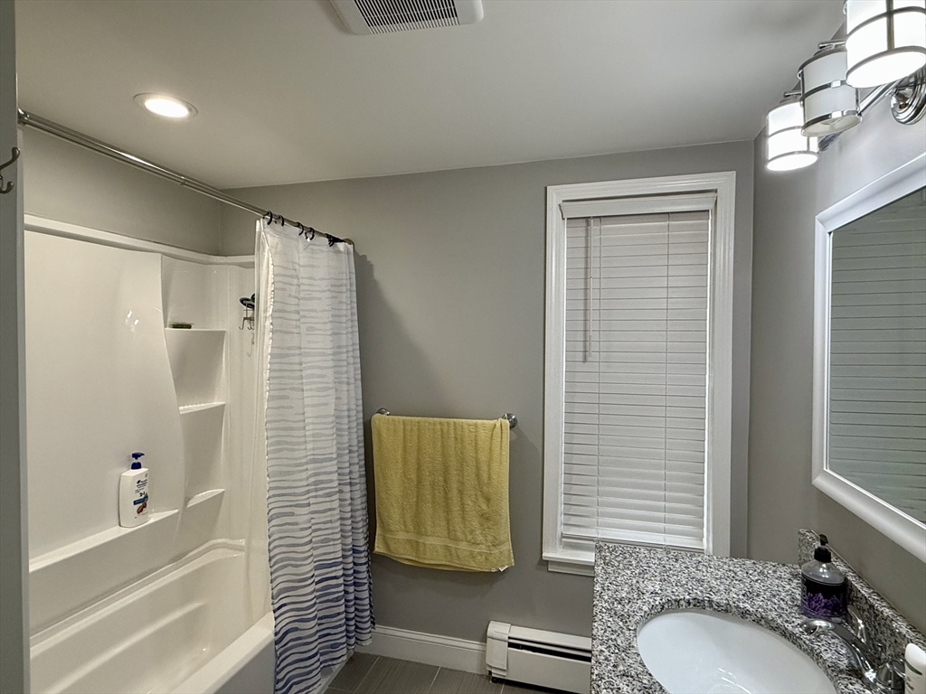 142 Cote Avenue Woonsocket, RI 02895 - Photo 4 of 22 a bathroom with a granite countertop sink and a mirror