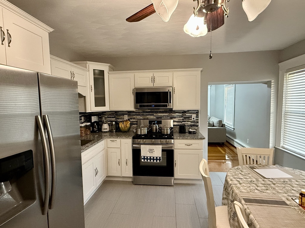 142 Cote Avenue Woonsocket, RI 02895 - Photo 6 of 22 a kitchen with stainless steel appliances granite countertop a refrigerator stove and sink