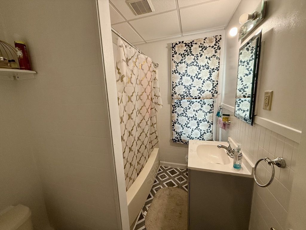 142 Cote Avenue Woonsocket, RI 02895 - Photo 9 of 22 a bathroom with a shower curtain and a sink