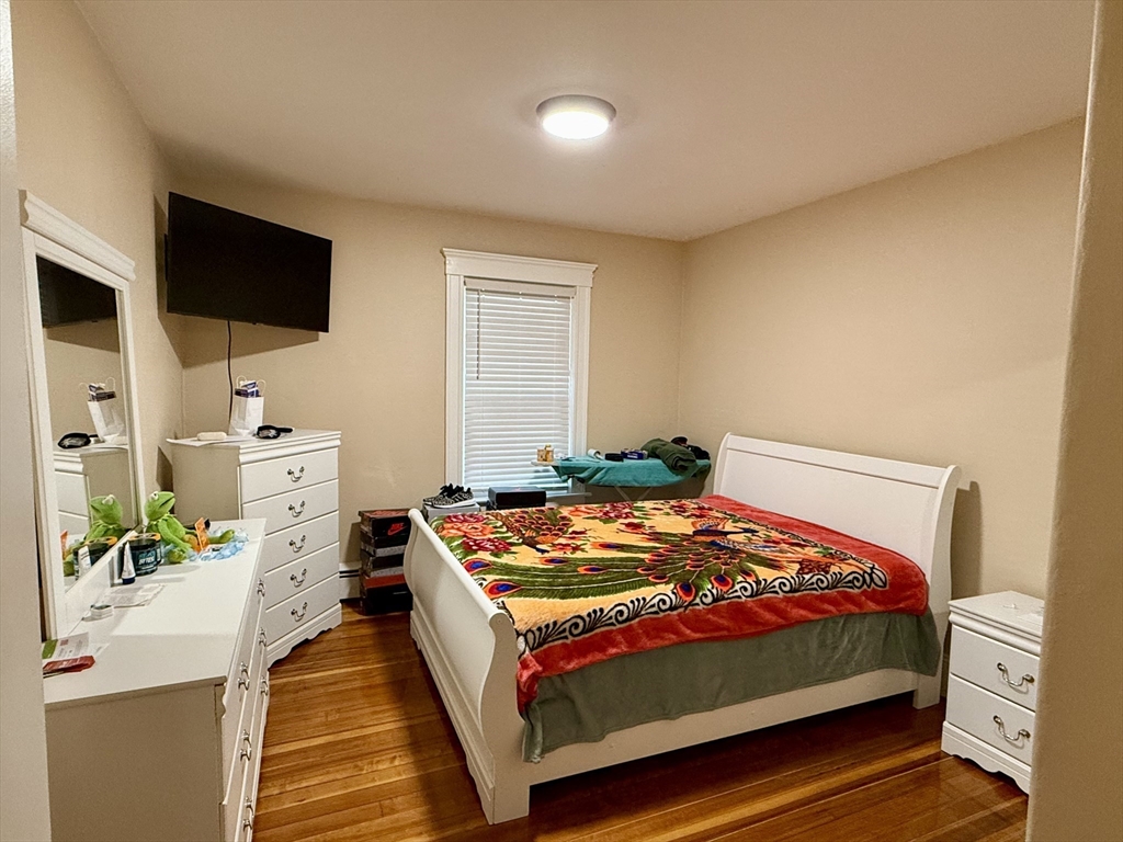 142 Cote Avenue Woonsocket, RI 02895 - Photo 10 of 22 a bedroom with a bed and a flat tv screen on the dresser