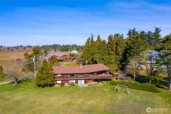 an aerial view of a house with swimming pool and deck