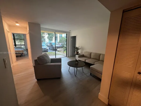 a living room with furniture and a large window