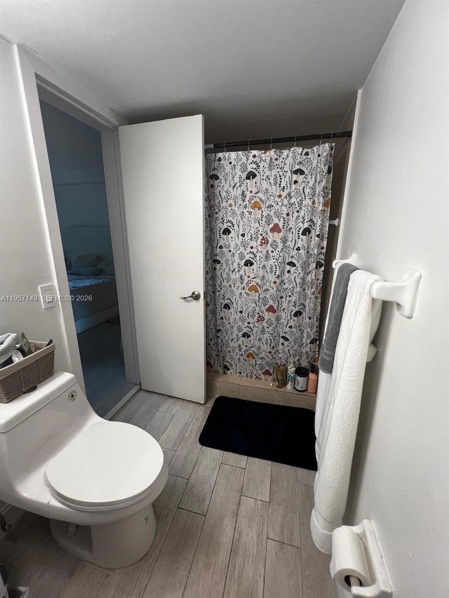 11750 Southwest 18th Street, Unit 1251 Miami, FL 33175 - Photo 11 of 15 a bathroom with a toilet and a shower