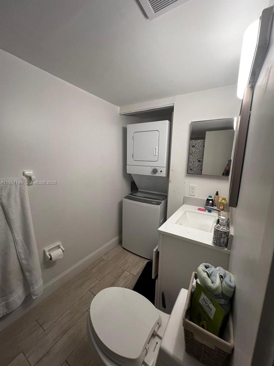 11750 Southwest 18th Street, Unit 1251 Miami, FL 33175 - Photo 12 of 15 a bathroom with a toilet a sink and mirror