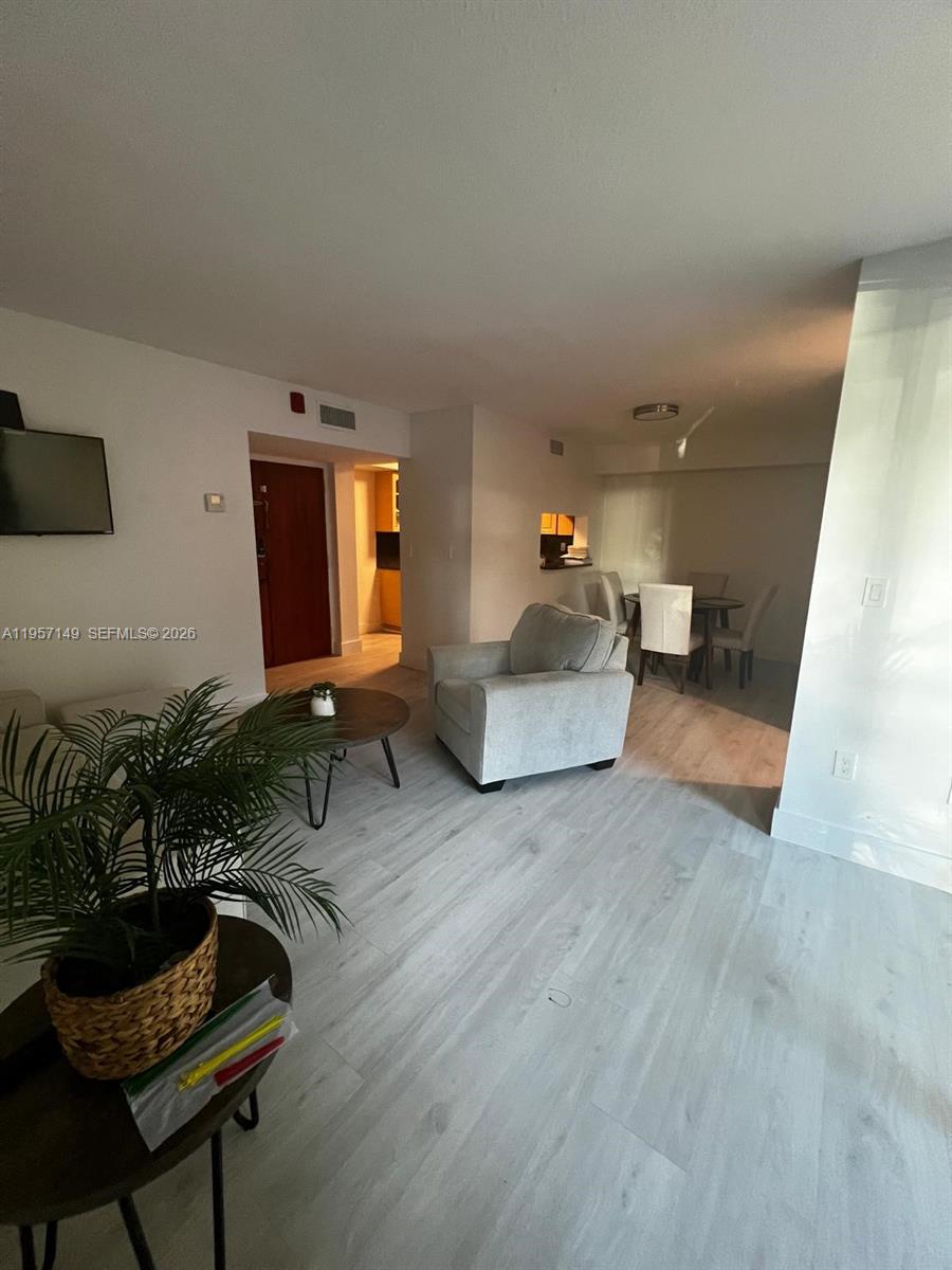 11750 Southwest 18th Street, Unit 1251 Miami, FL 33175 - Photo 2 of 15 a living room with furniture and wooden floor