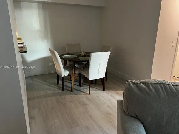 a view of a workspace with furniture and wooden floor