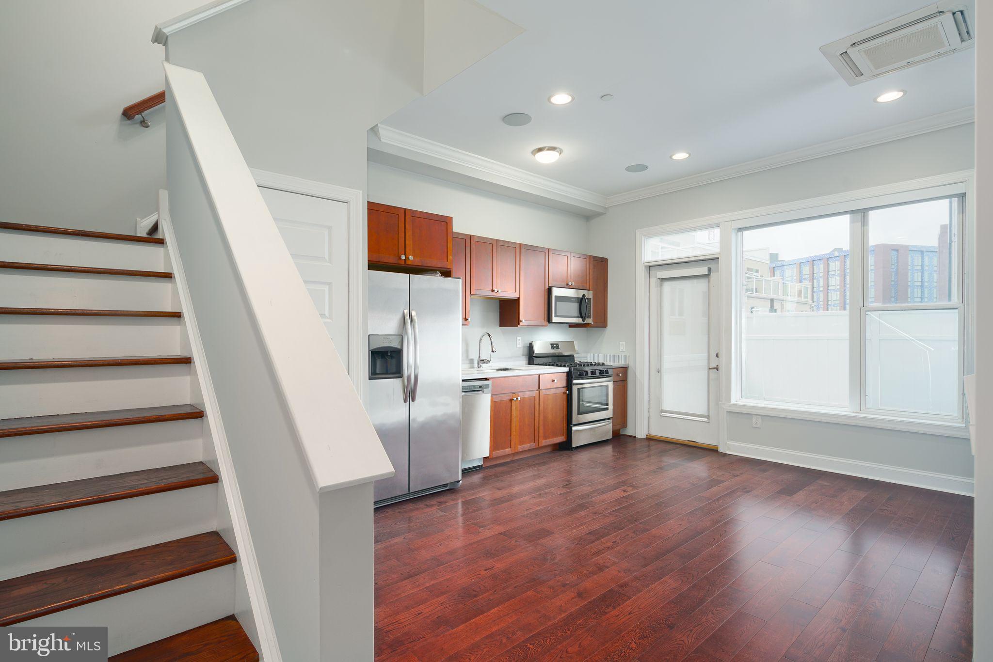 901 North Front Street, Unit 5 Philadelphia, PA 19123 - Photo 2 of 12 a view of kitchen with wooden floor and electronic appliances