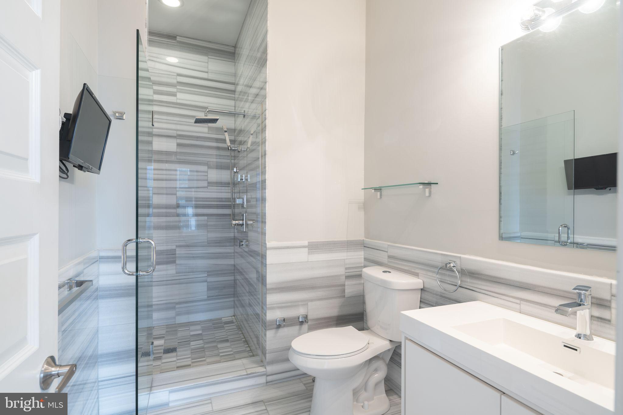901 North Front Street, Unit 5 Philadelphia, PA 19123 - Photo 4 of 12 a bathroom with a sink toilet and shower