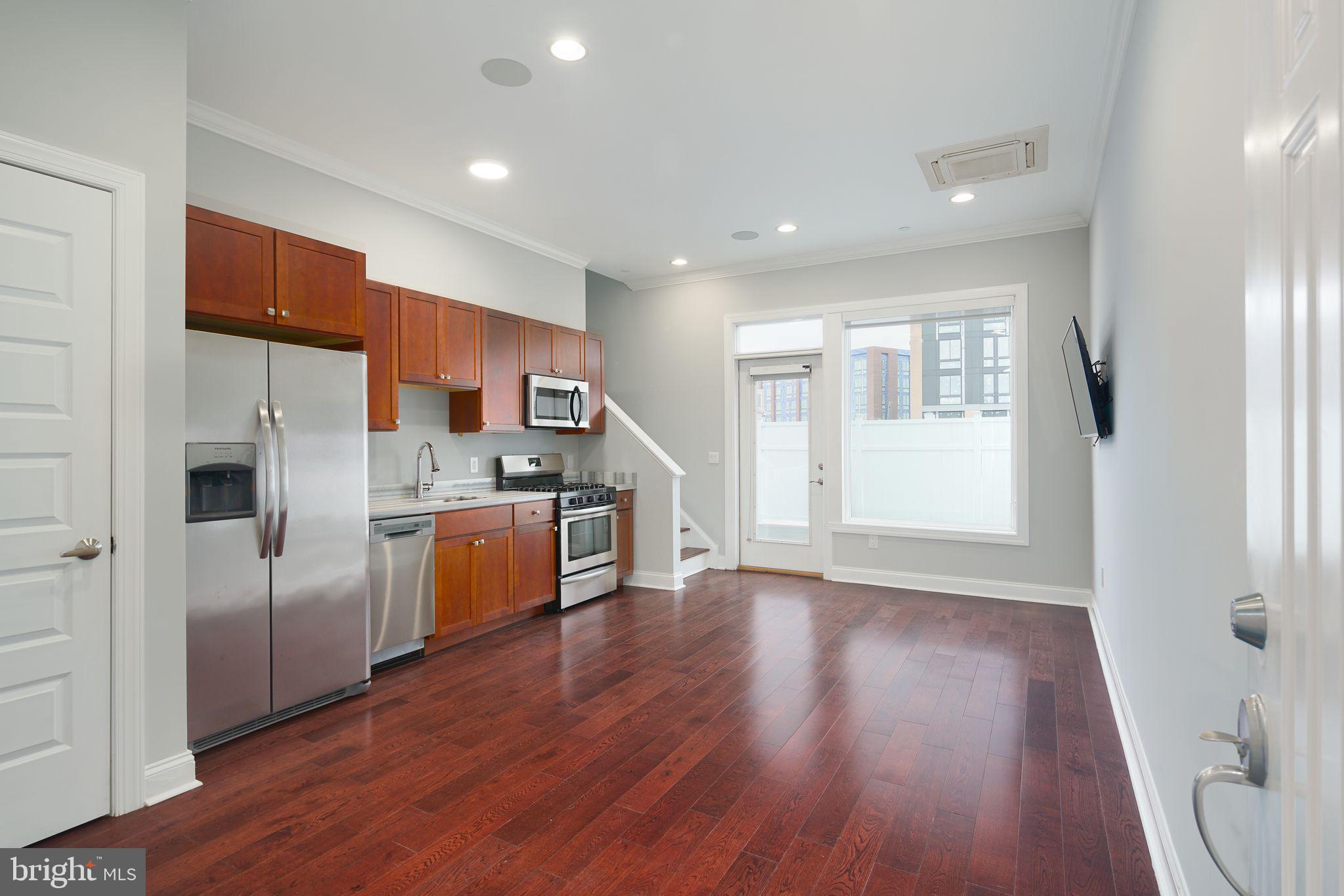 901 North Front Street, Unit 5 Philadelphia, PA 19123 - Photo 7 of 12 a kitchen with a refrigerator and a stove top oven