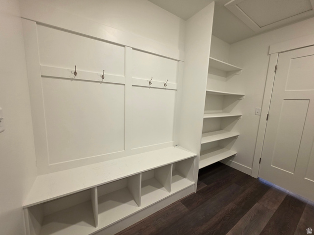 1237 West 3440 South Logan, UT 84321 - Photo 25 of 29 Built-in mudroom bench with cubby storage, integrated wall hooks, open shelving, and dark wood-finish flooring