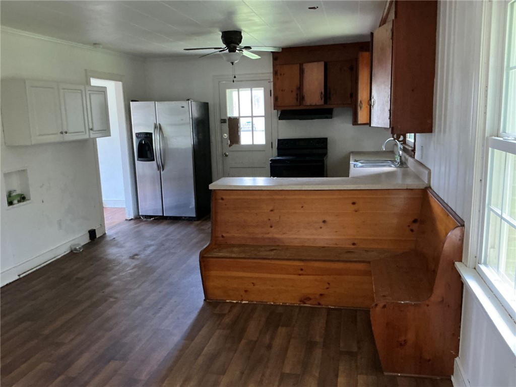 609 West Geer Street Honea Path, SC 29654 - Photo 6 of 18 Rich wood floors and a unique built-in bench highlight this traditional kitchen space.
