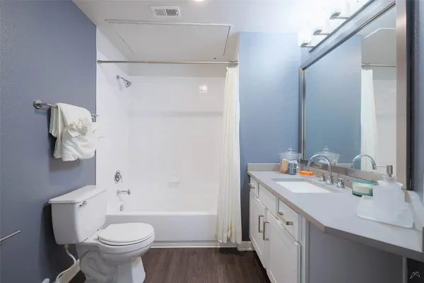 a bathroom with a double vanity sink toilet and shower