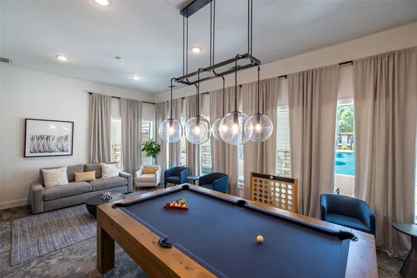 a living room with furniture a chandelier and a window