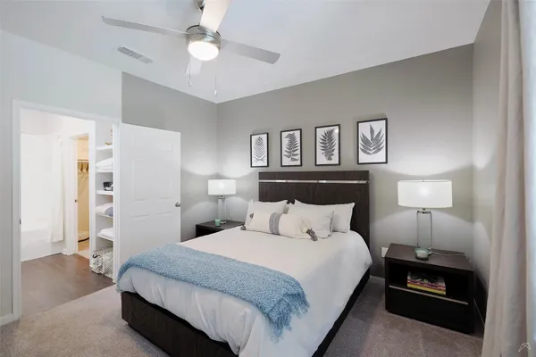 a bedroom with a bed and a lamp