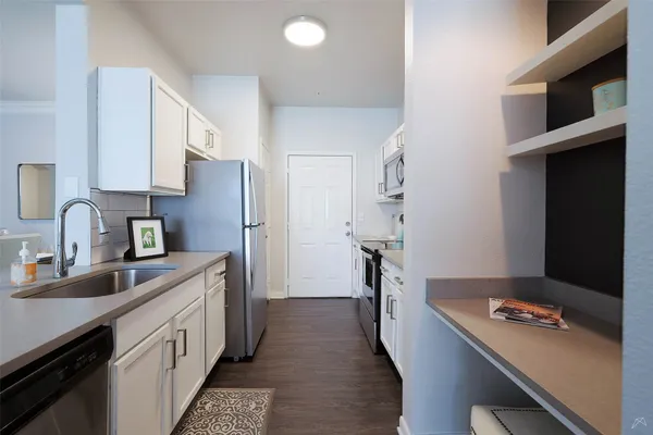 a kitchen with a sink stove and refrigerator