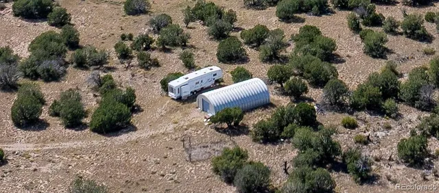 an aerial view of a house with a yard