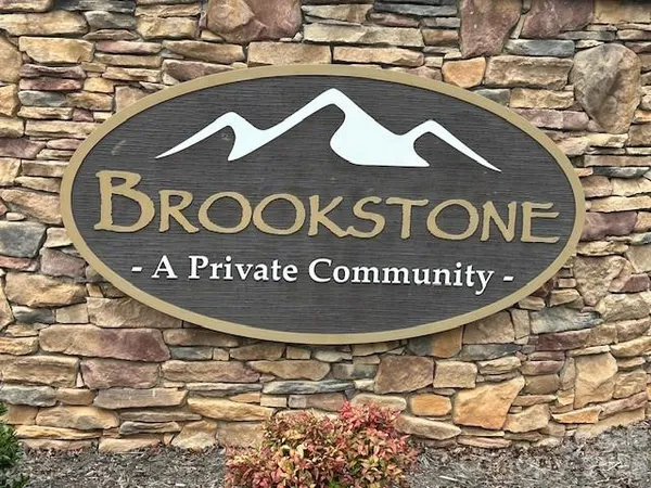 a blue sign that is sitting on a wooden floor