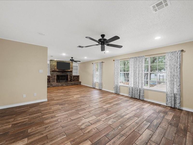 1072 Chapman Road Crawford, TX 76638 - Photo 14 of 39 a view of an empty room with a window and wooden floor