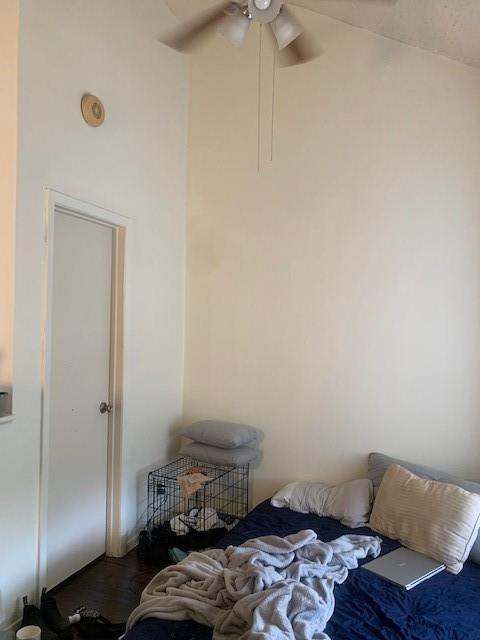 912 West 22nd 1/2 Street, Unit F Austin, TX 78705 - Photo 11 of 14 Bedroom with ceiling fan and wood finished floors