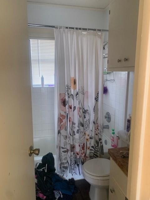 912 West 22nd 1/2 Street, Unit F Austin, TX 78705 - Photo 12 of 14 Full bathroom with vanity and shower / bathtub combination with curtain