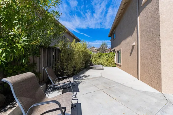 a view of a chair and table in backyard
