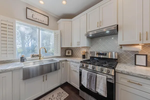 a view of living room with kitchen island granite countertop furniture and fireplace