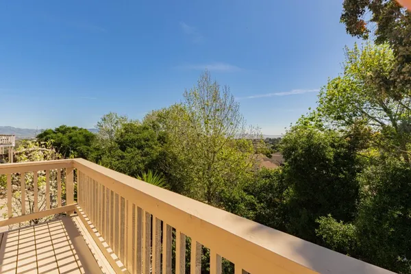 a view of a balcony with wooden fence and floor