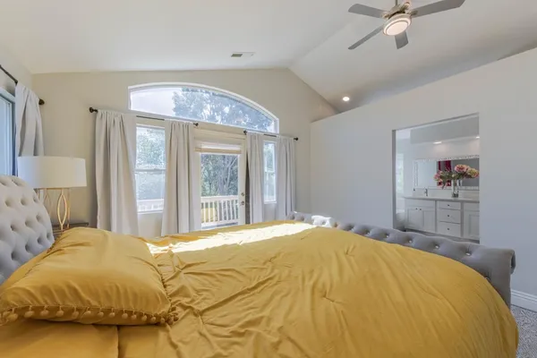 a bedroom with a bed and a lamp