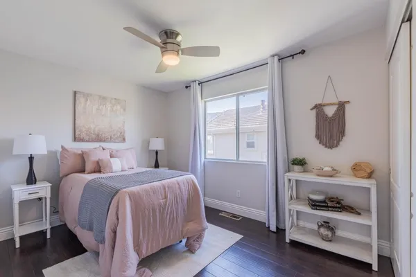 a bedroom with a large bed and a chandelier