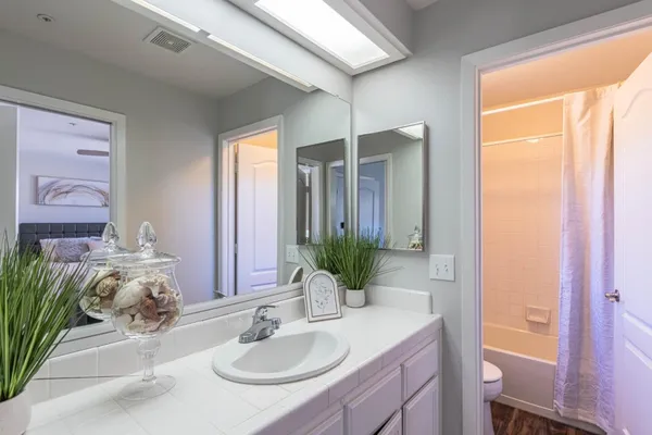 a bathroom with a granite countertop sink a mirror and a