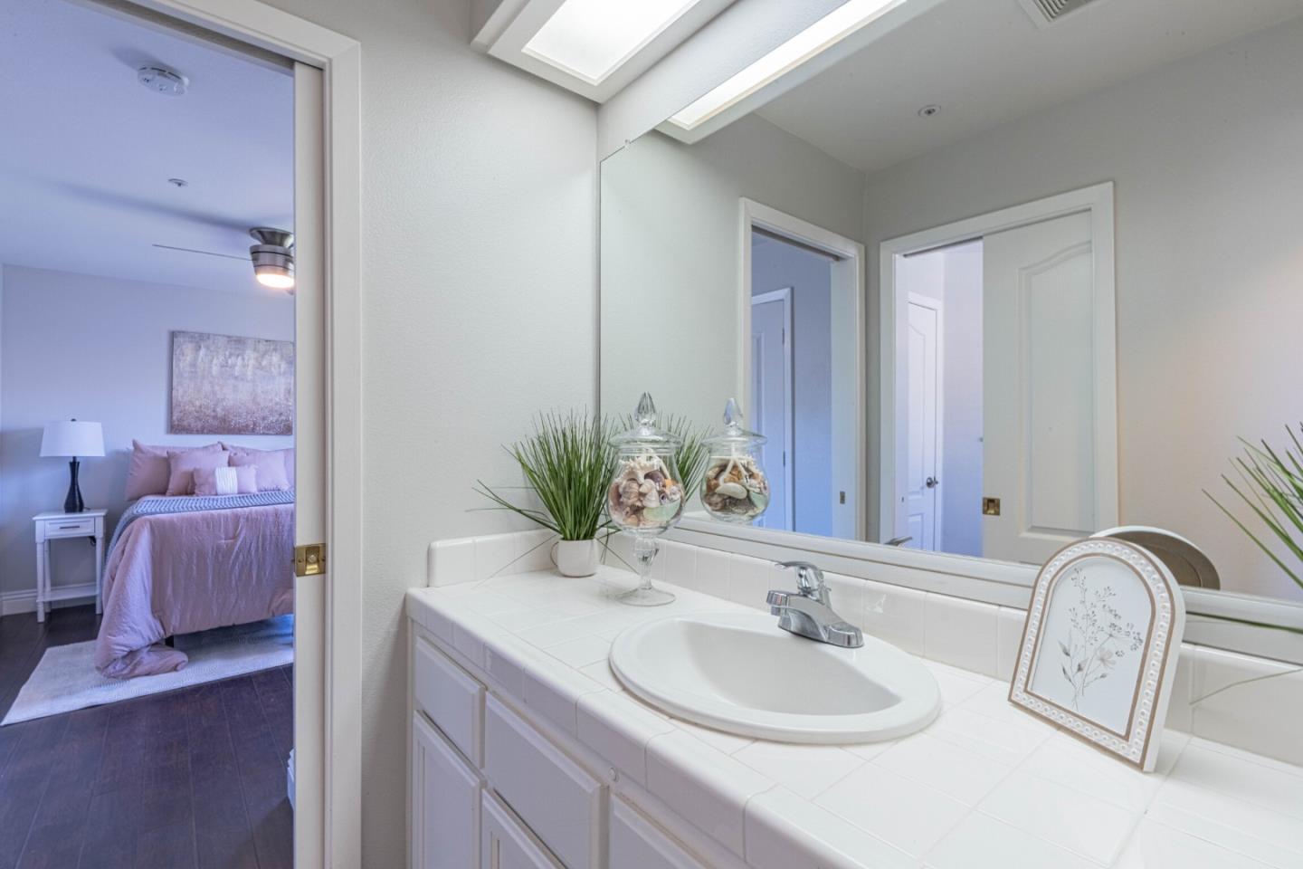 25215 Azalea Court Salinas, CA 93908 - Photo 38 of 48 a bathroom with a granite countertop sink a mirror and a
