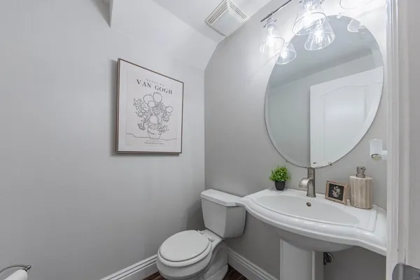 a view of washer and dryer with bathroom in the background