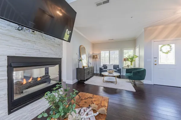 a living room with furniture wooden floor and a fireplace