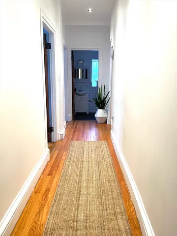 a view of a room with wooden floor and furniture