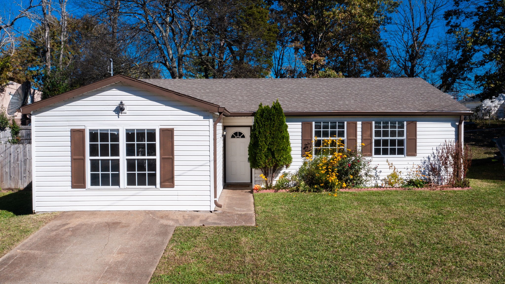 253 Warrior Road Madison, TN 37115 - Photo 1 of 43 a house that has a big yard with potted plants and large trees