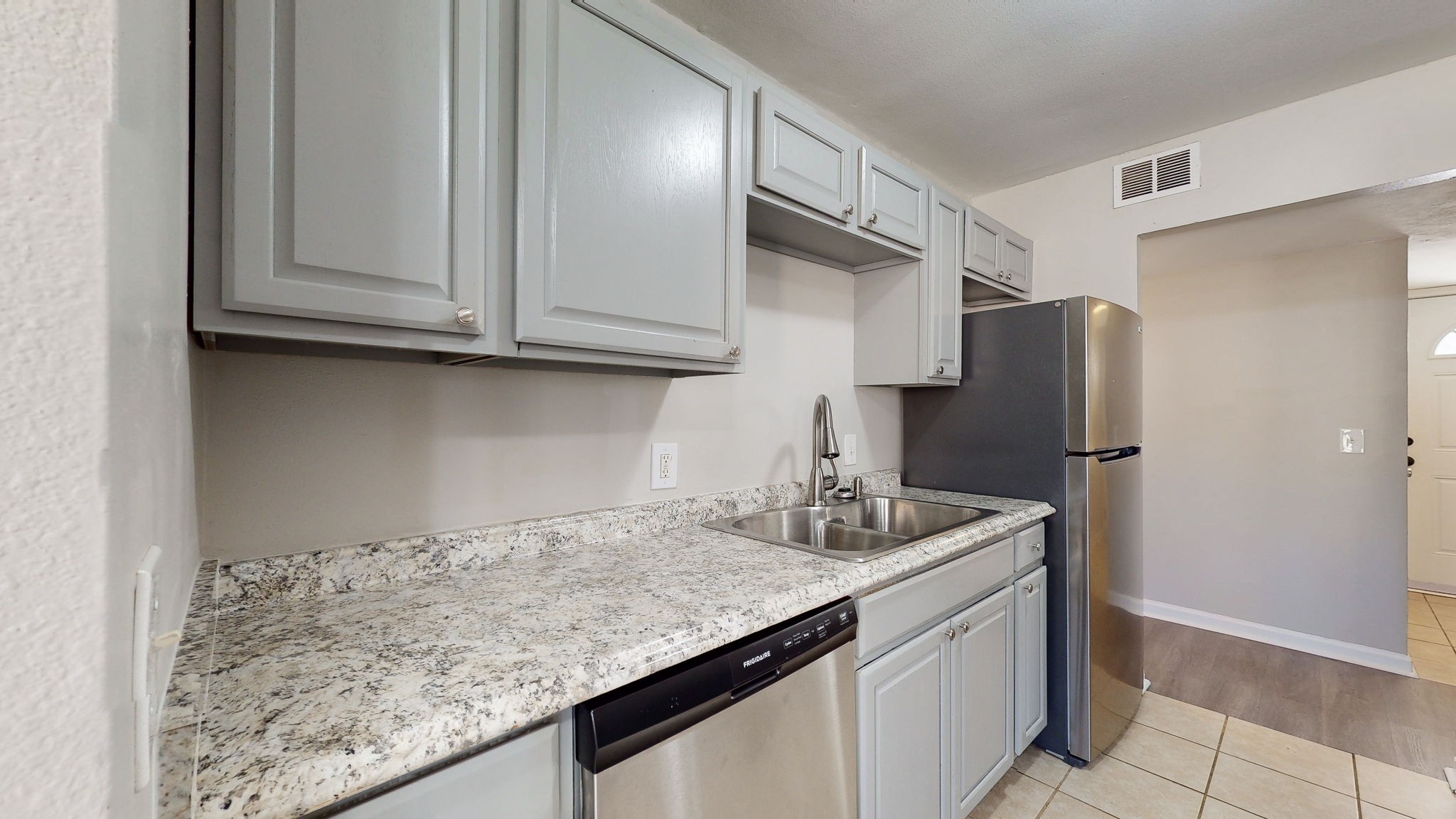 253 Warrior Road Madison, TN 37115 - Photo 11 of 43 a kitchen with stainless steel appliances granite countertop a sink and a refrigerator