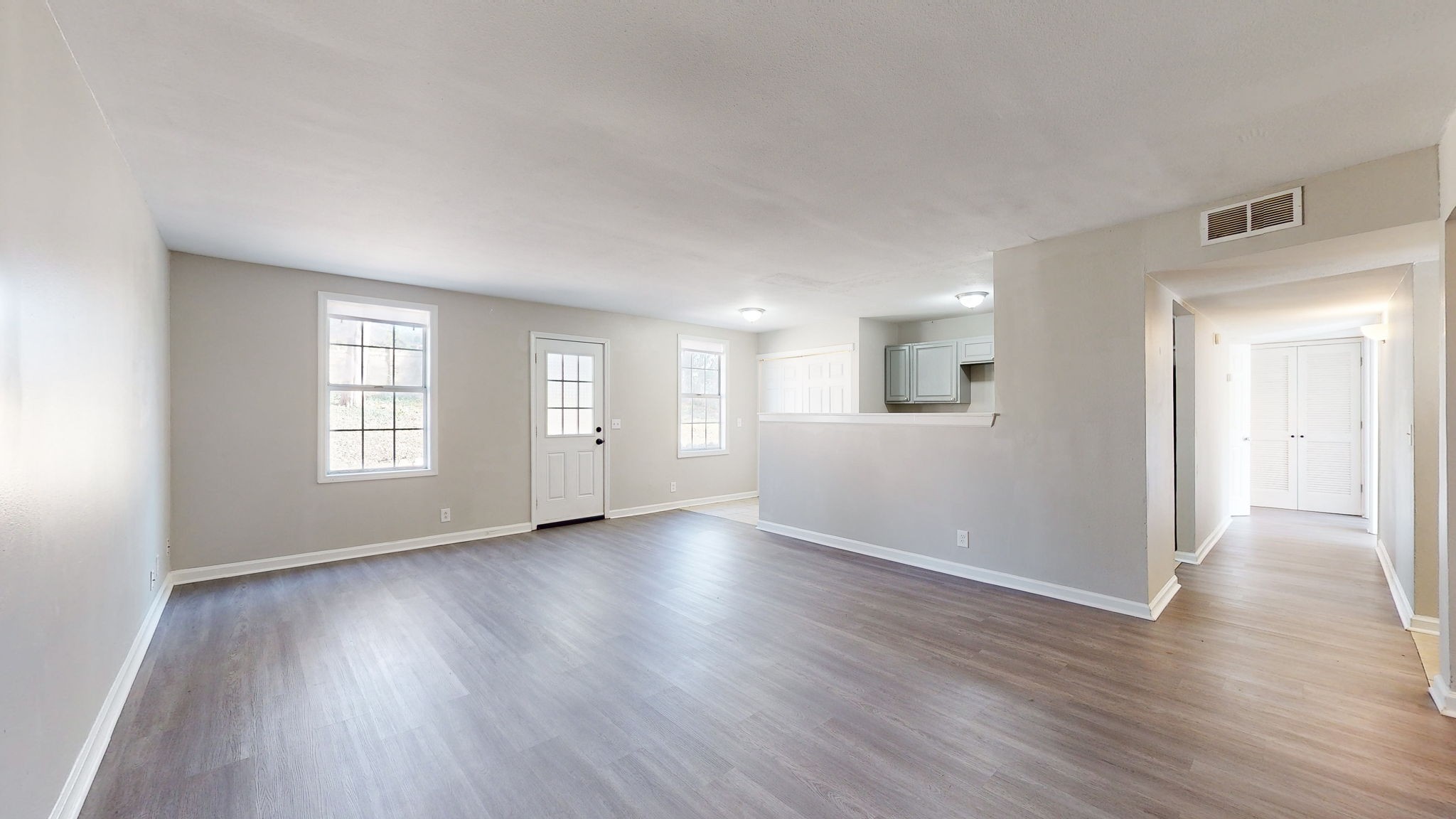253 Warrior Road Madison, TN 37115 - Photo 5 of 43 an empty room with wooden floor and windows
