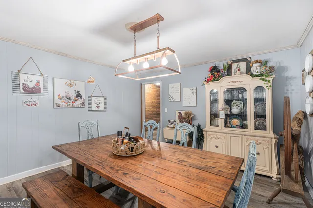 a view of a dining room with furniture and a chandelier
