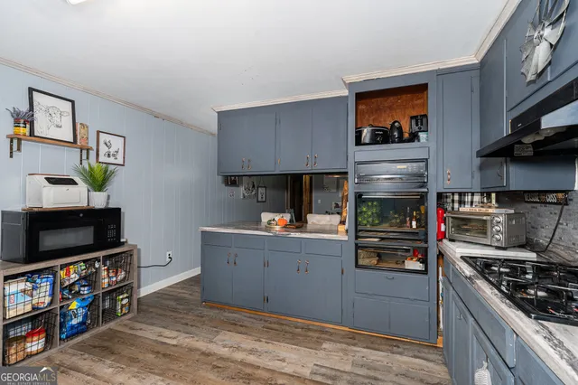a kitchen with stainless steel appliances granite countertop a stove and a refrigerator