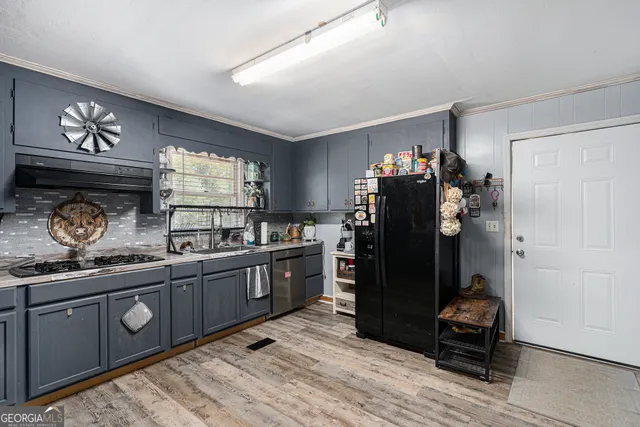 a kitchen with a refrigerator and a stove