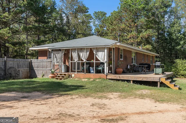 a view of a house with pool and a yard
