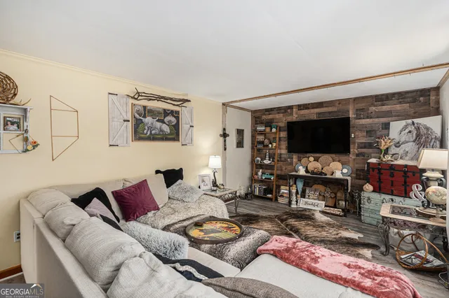 a living room with furniture and a flat screen tv