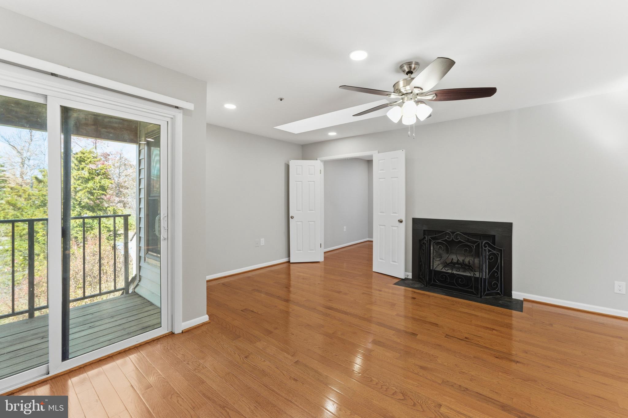 13406 Shady Knoll Drive, Unit 305 Silver Spring, MD 20904 - Photo 14 of 37 a view of an empty room with a fireplace and a window