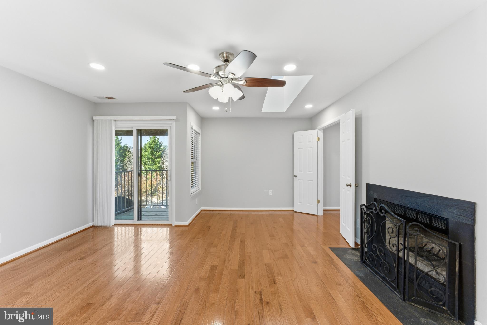 13406 Shady Knoll Drive, Unit 305 Silver Spring, MD 20904 - Photo 15 of 37 a view of an empty room with a window and wooden floor