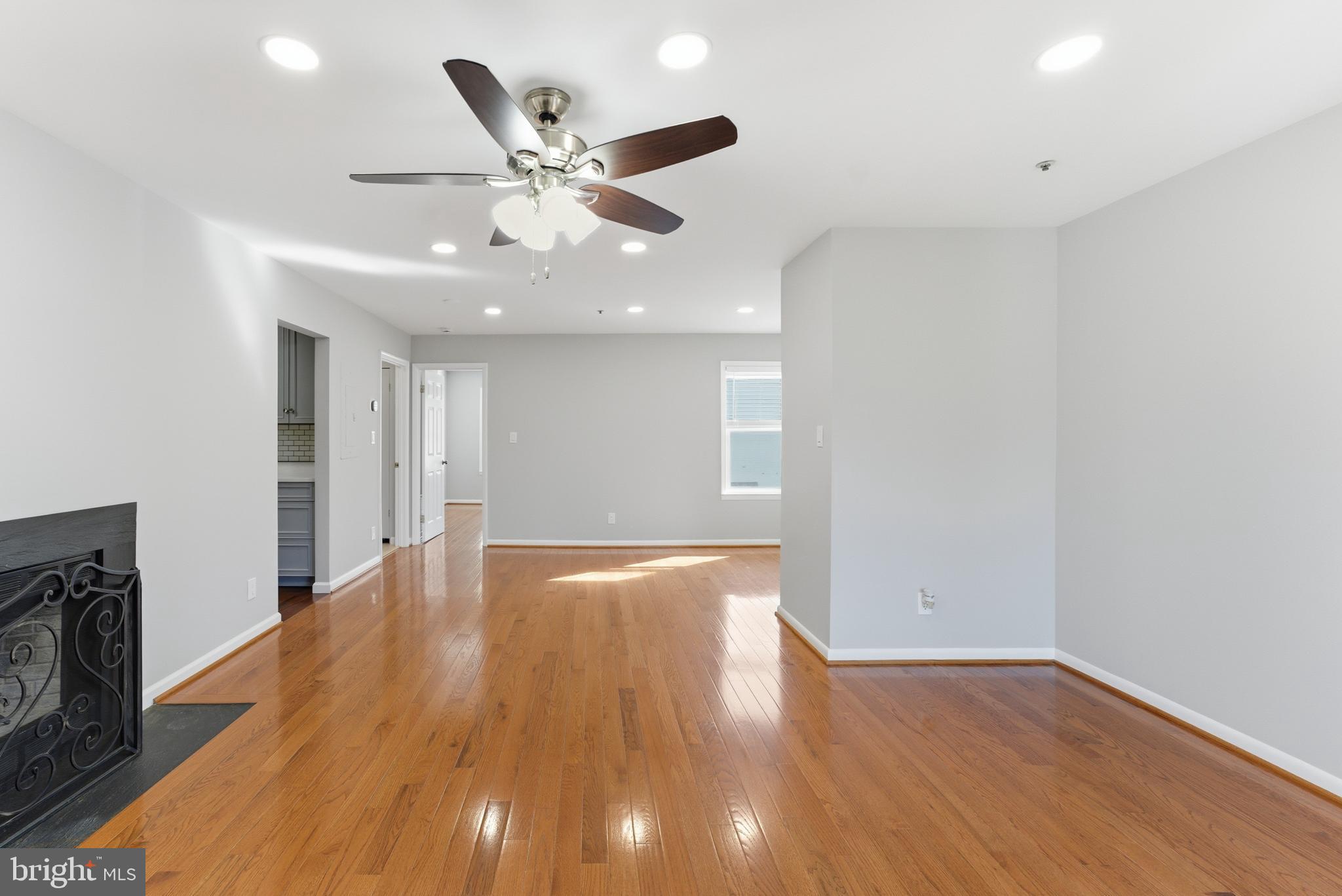 13406 Shady Knoll Drive, Unit 305 Silver Spring, MD 20904 - Photo 17 of 37 a view of an empty room with wooden floor and a fireplace