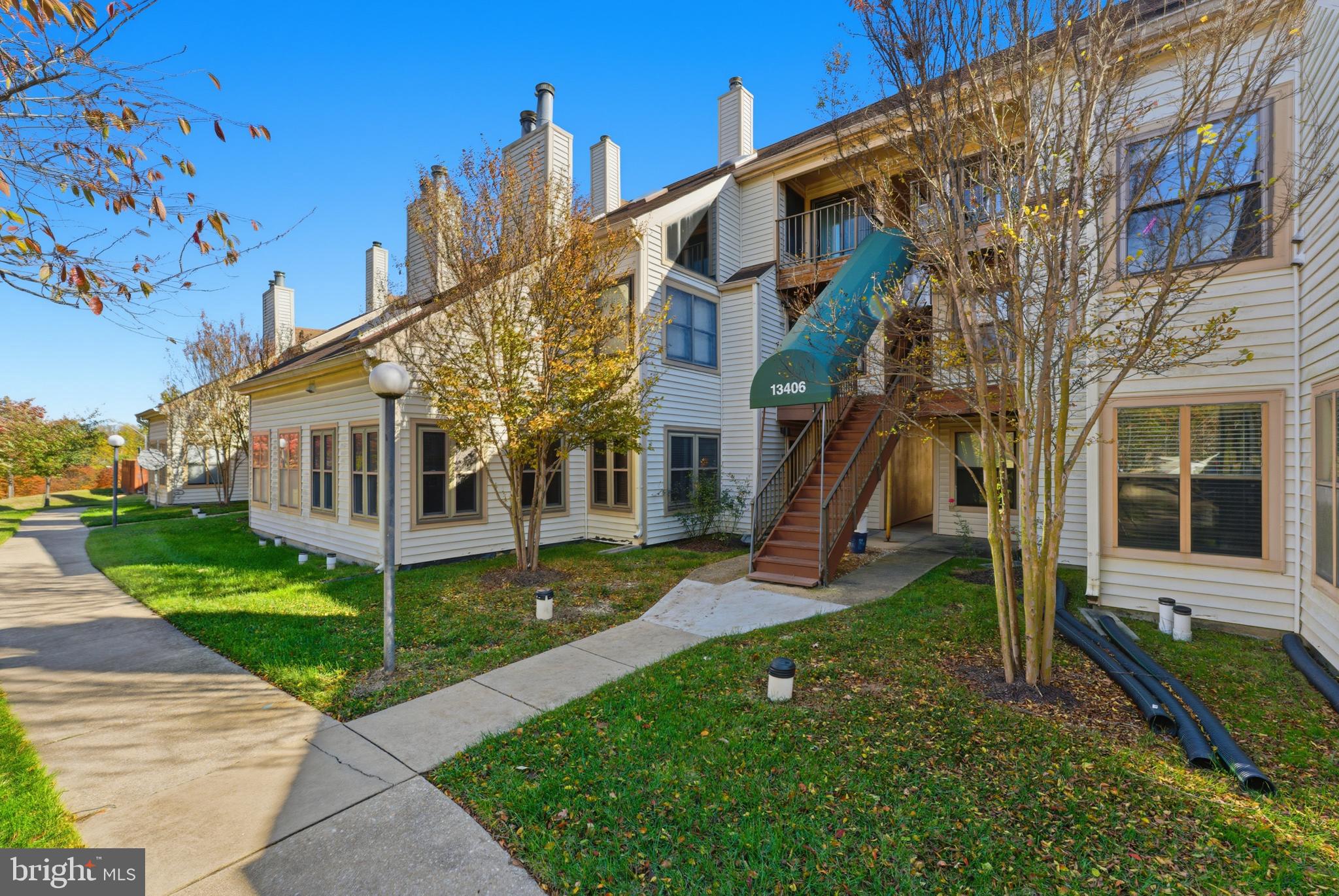 13406 Shady Knoll Drive, Unit 305 Silver Spring, MD 20904 - Photo 2 of 37 a view of a white house with a yard