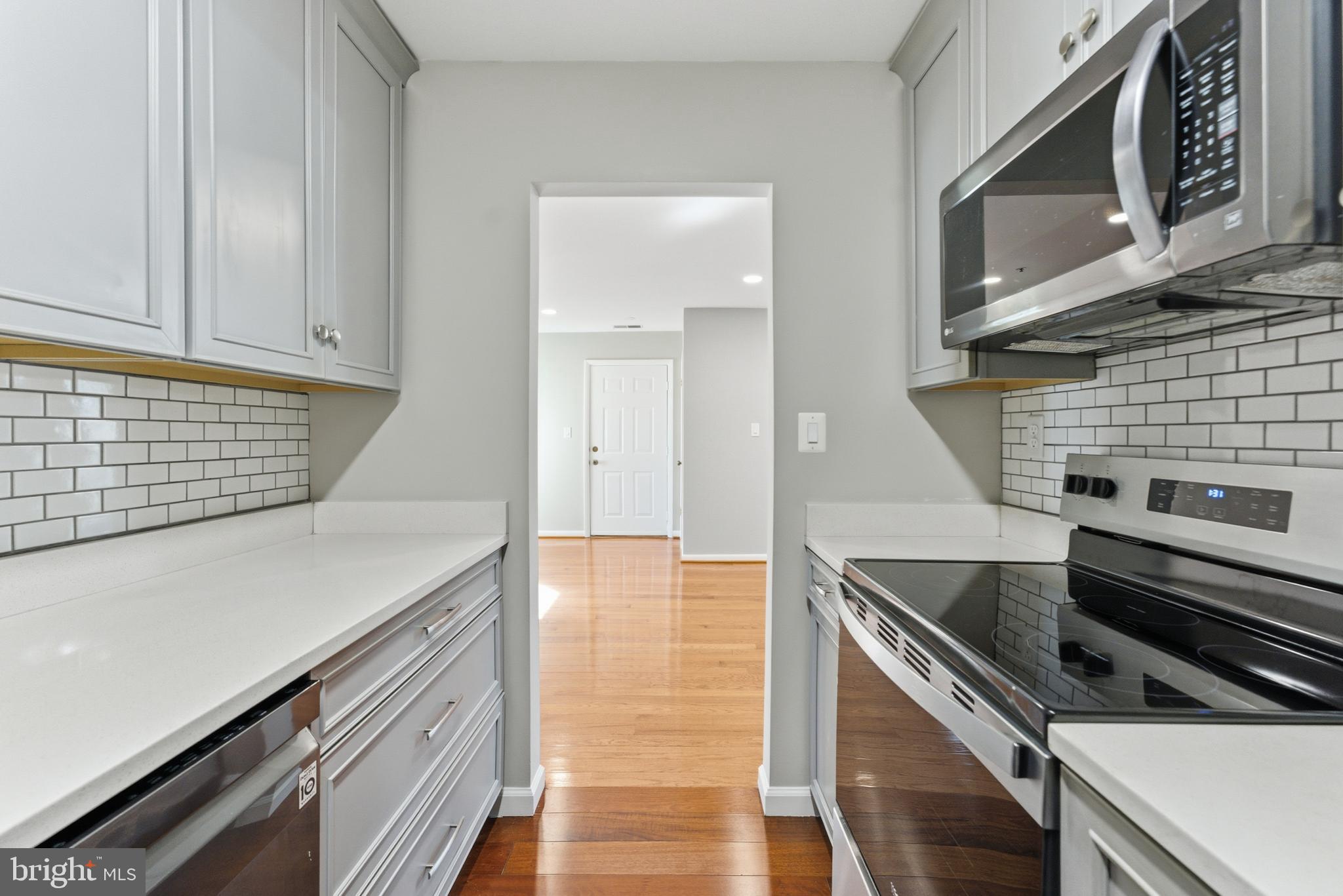 13406 Shady Knoll Drive, Unit 305 Silver Spring, MD 20904 - Photo 23 of 37 a kitchen with granite countertop a stove and a sink