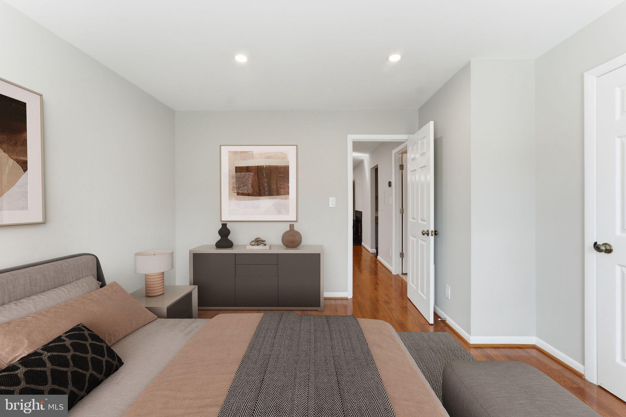 13406 Shady Knoll Drive, Unit 305 Silver Spring, MD 20904 - Photo 27 of 37 a living room with furniture and a wooden floor
