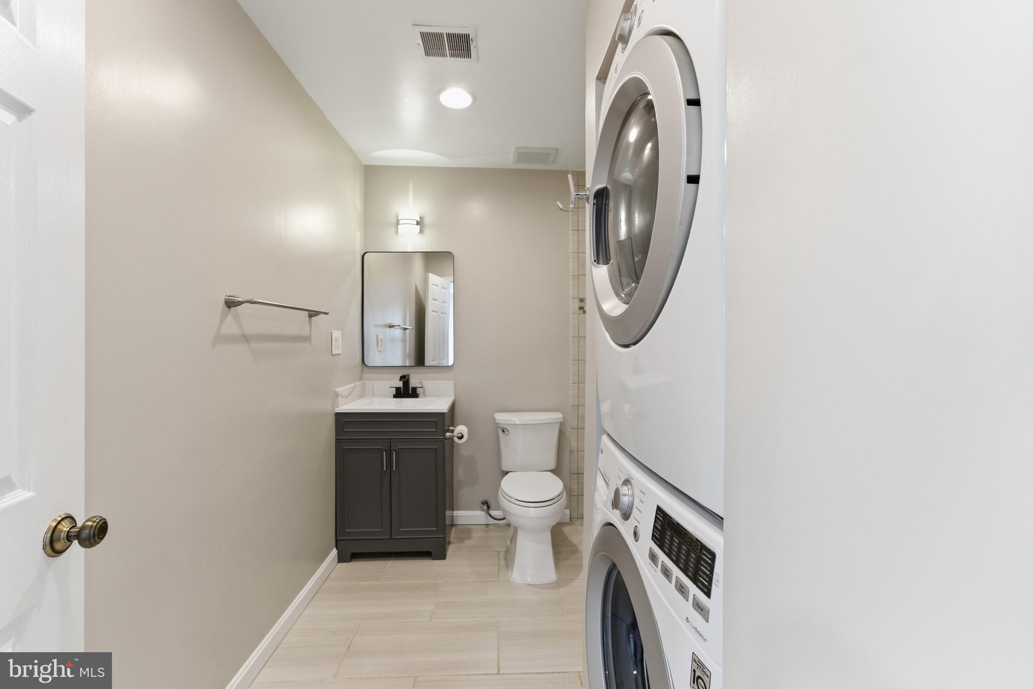 13406 Shady Knoll Drive, Unit 305 Silver Spring, MD 20904 - Photo 33 of 37 a spacious bathroom with a toilet sink and mirror