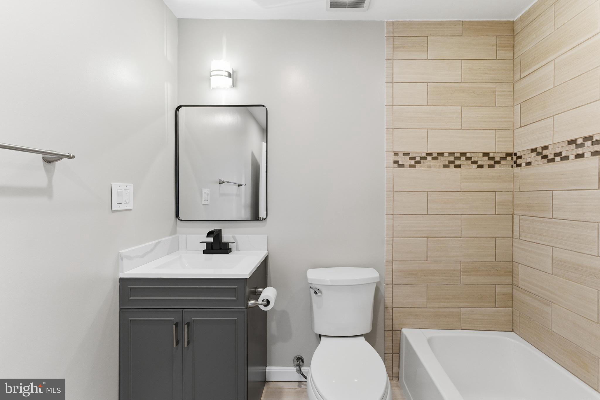 13406 Shady Knoll Drive, Unit 305 Silver Spring, MD 20904 - Photo 35 of 37 a bathroom with a sink toilet and shower